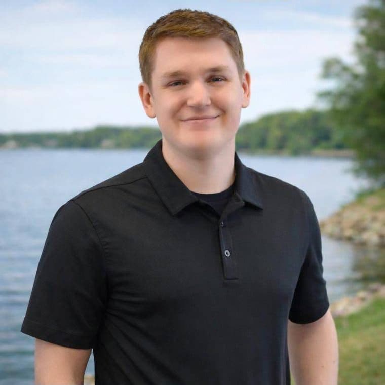 Tanner Braun, REALTOR with Hall Realty, standing by Clear Lake