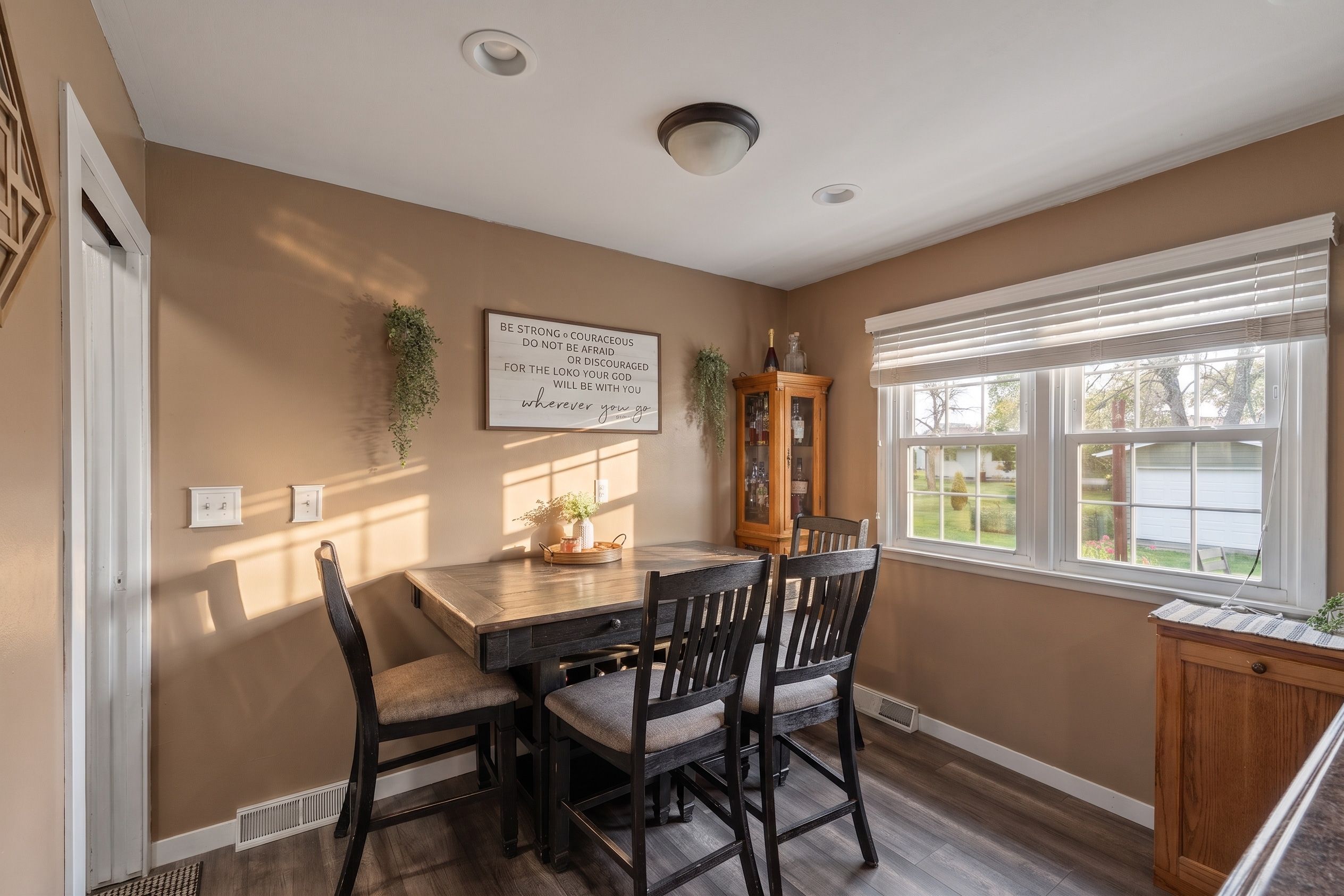 Warm dining area in a Clear Lake home with natural light, wood furniture, and a comfortable neighborhood feel