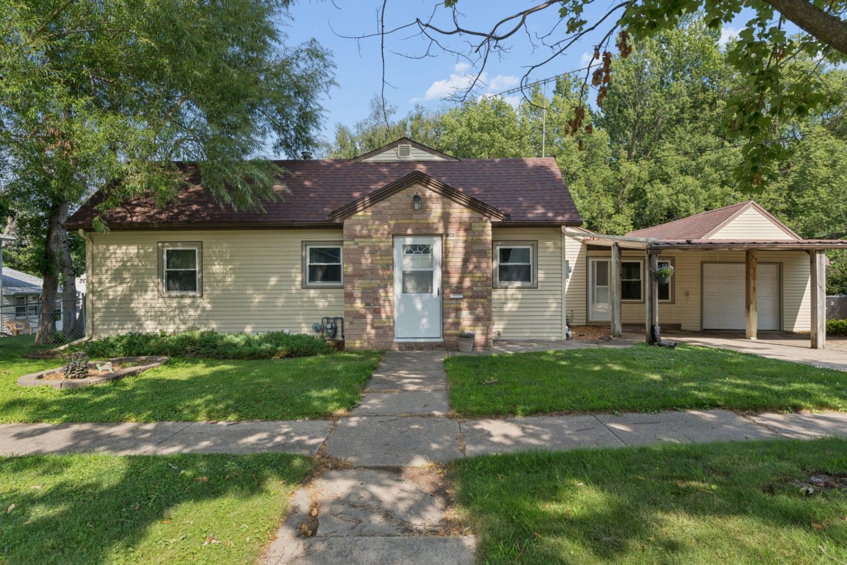 A welcoming Clear Lake home exterior with mature trees and a quiet residential setting