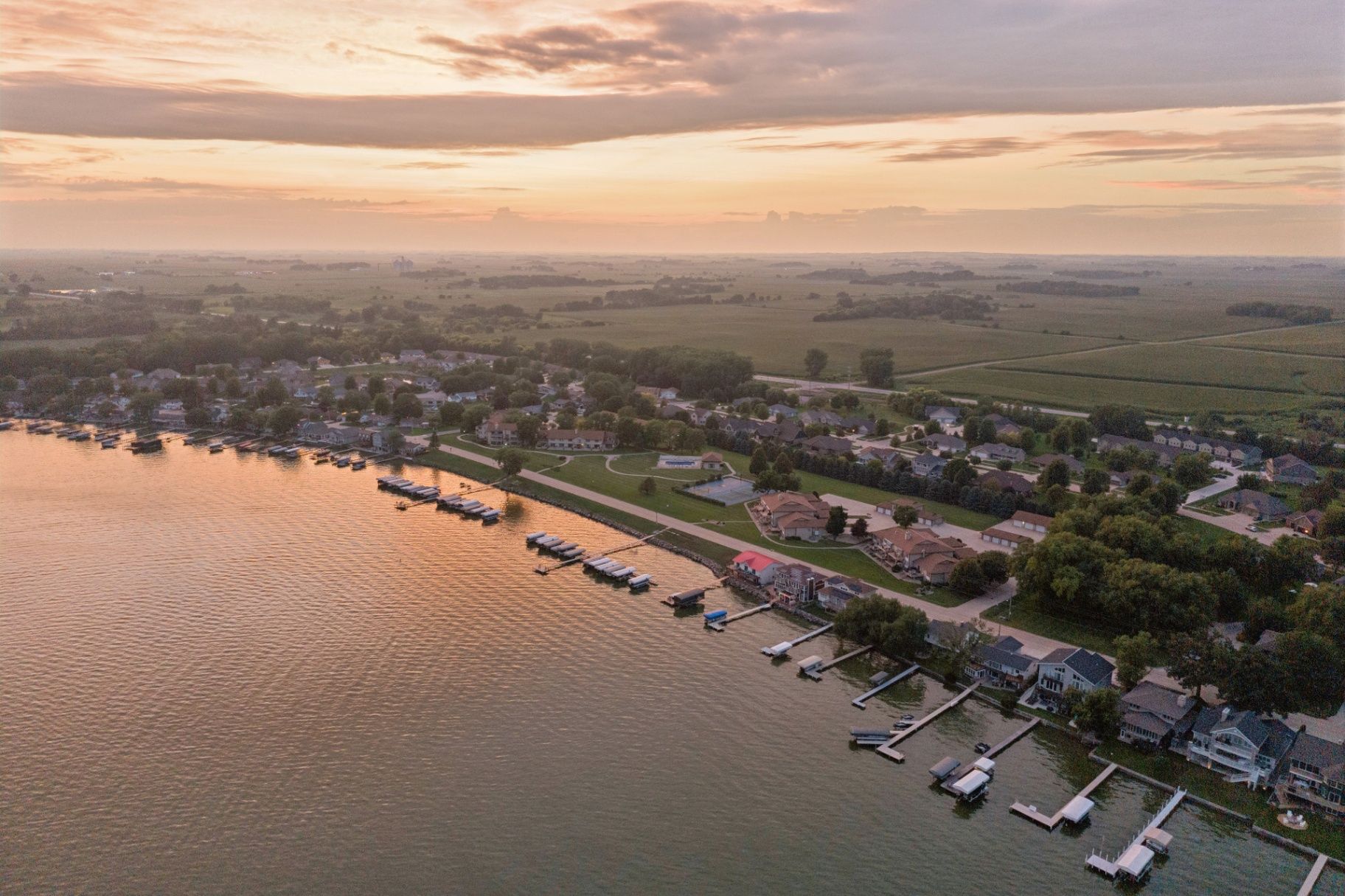 A peaceful aerial view of Clear Lake homes, docks, and shoreline during golden hour