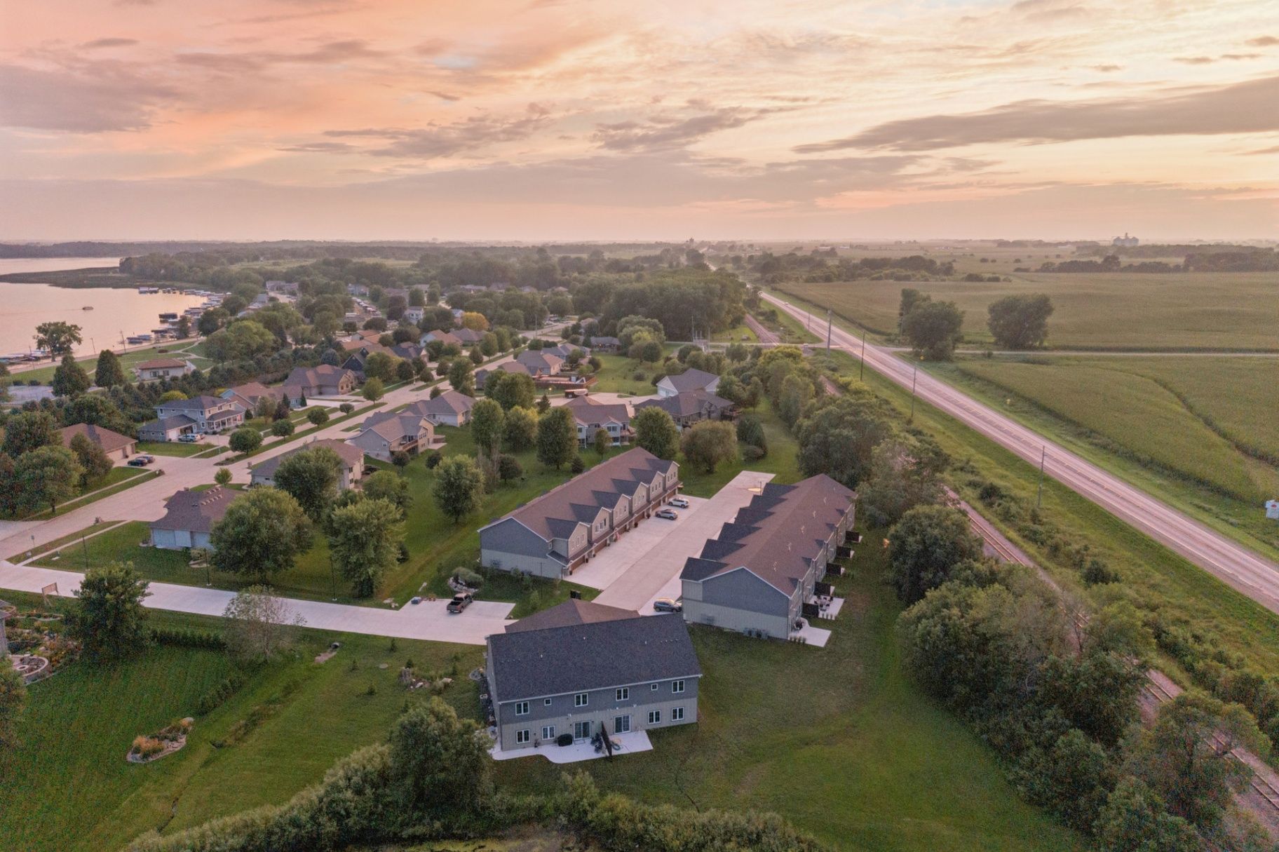 Clear Lake shoreline neighborhoods glowing beneath a soft sunset sky