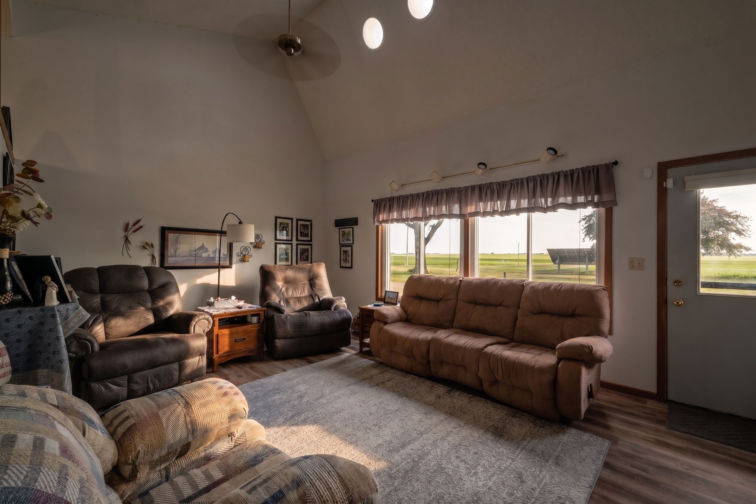 Warm Clear Lake living room with large windows overlooking open countryside